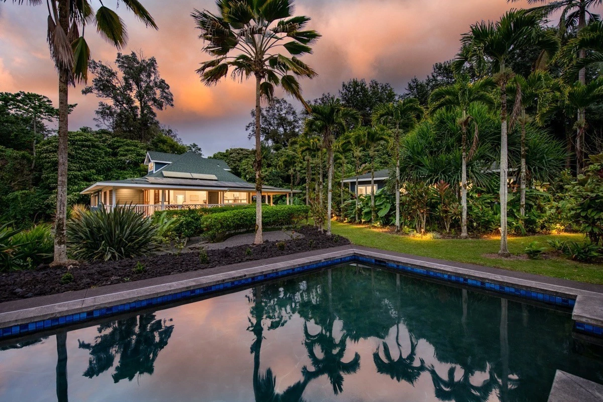 Outdoor pool surrounded by palm trees