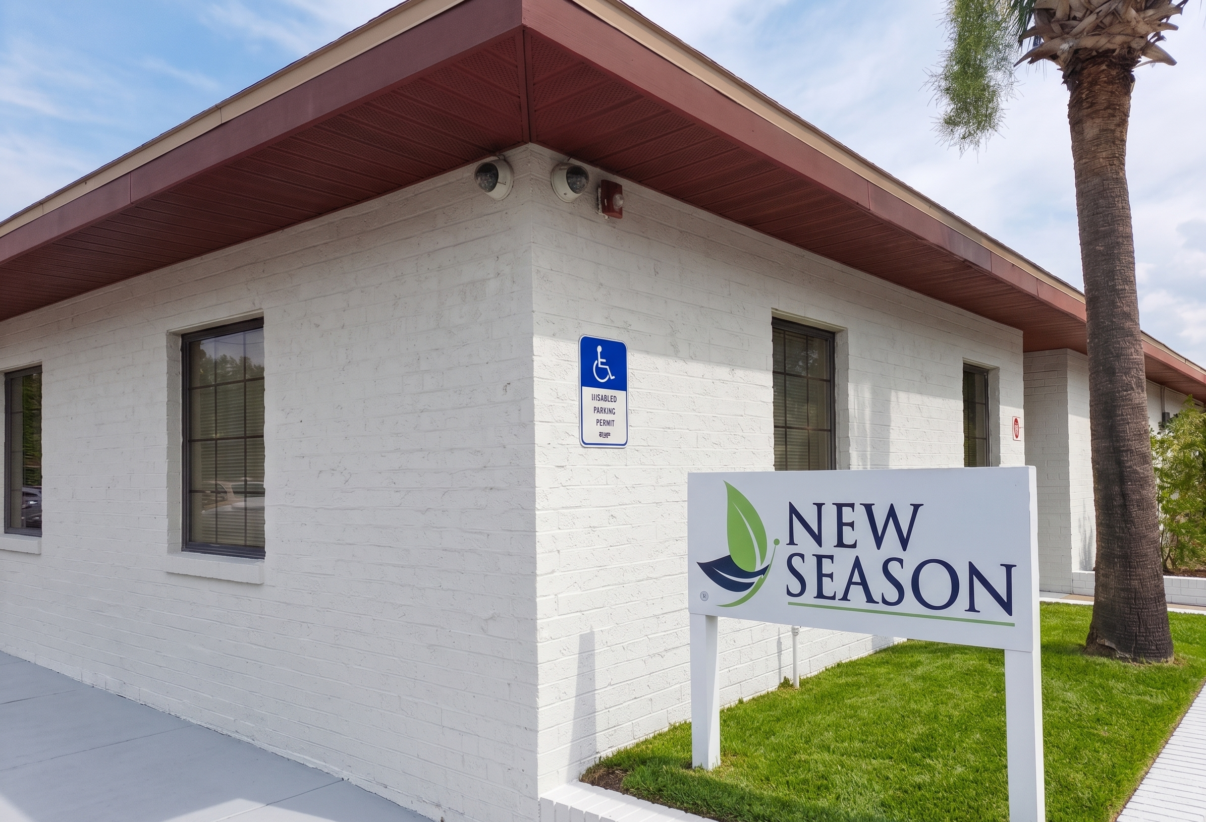 New Season sign outside white brick treatment center building