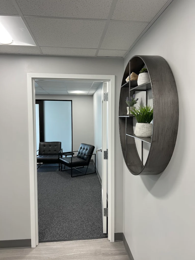 Modern treatment room with chairs and small shelf