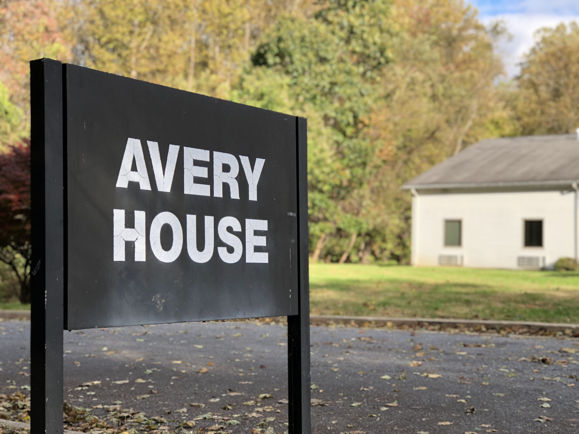 Avery House sign in front of a wooded residential facility