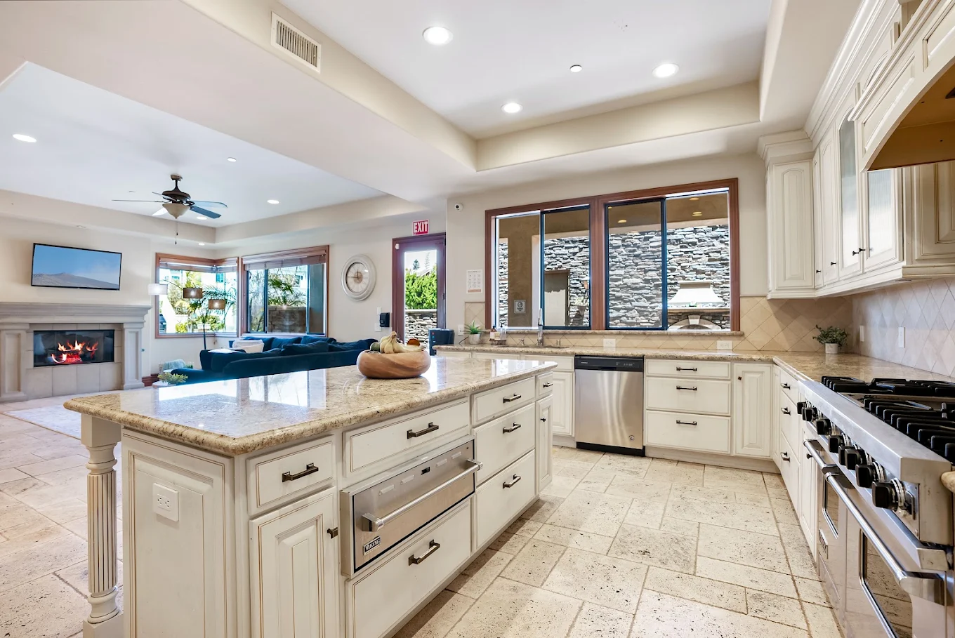 Spacious kitchen with large island and white cabinetry