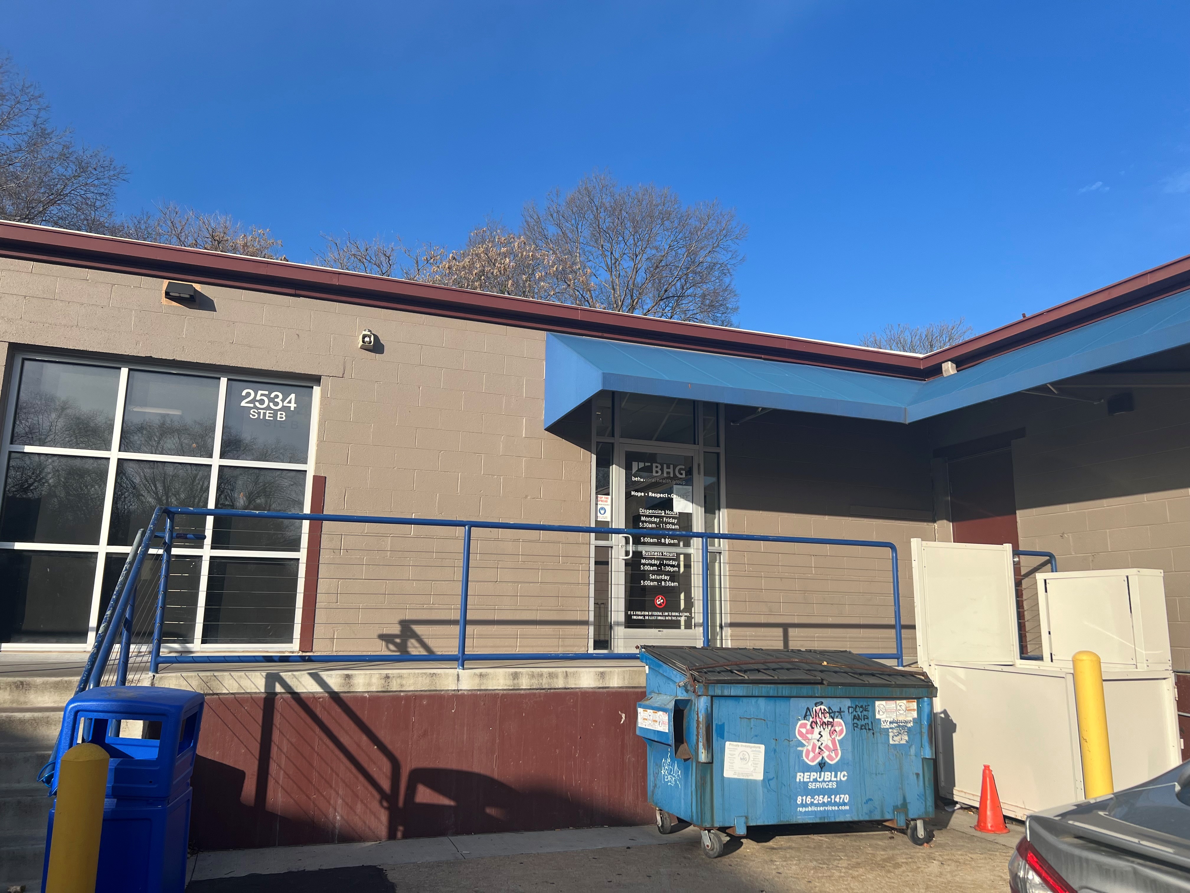 Main entrance with blue awning and accessible ramp