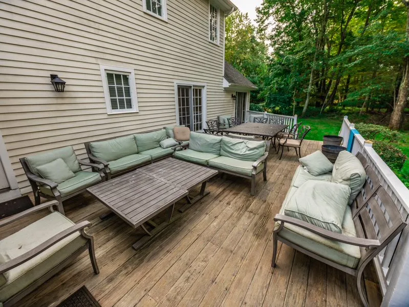 Outdoor deck with cushioned seating and dining table