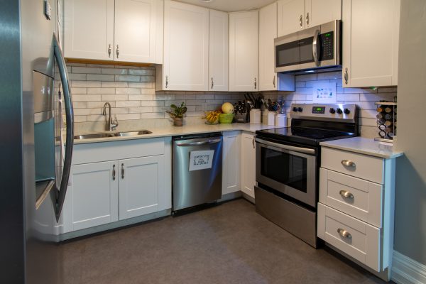 White cabinetry and stainless appliances in kitchen