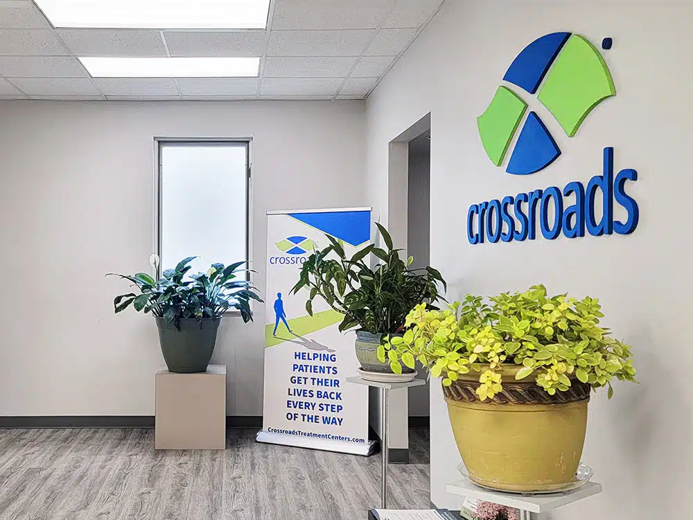 Lobby with Crossroads logo, plants, and informational display