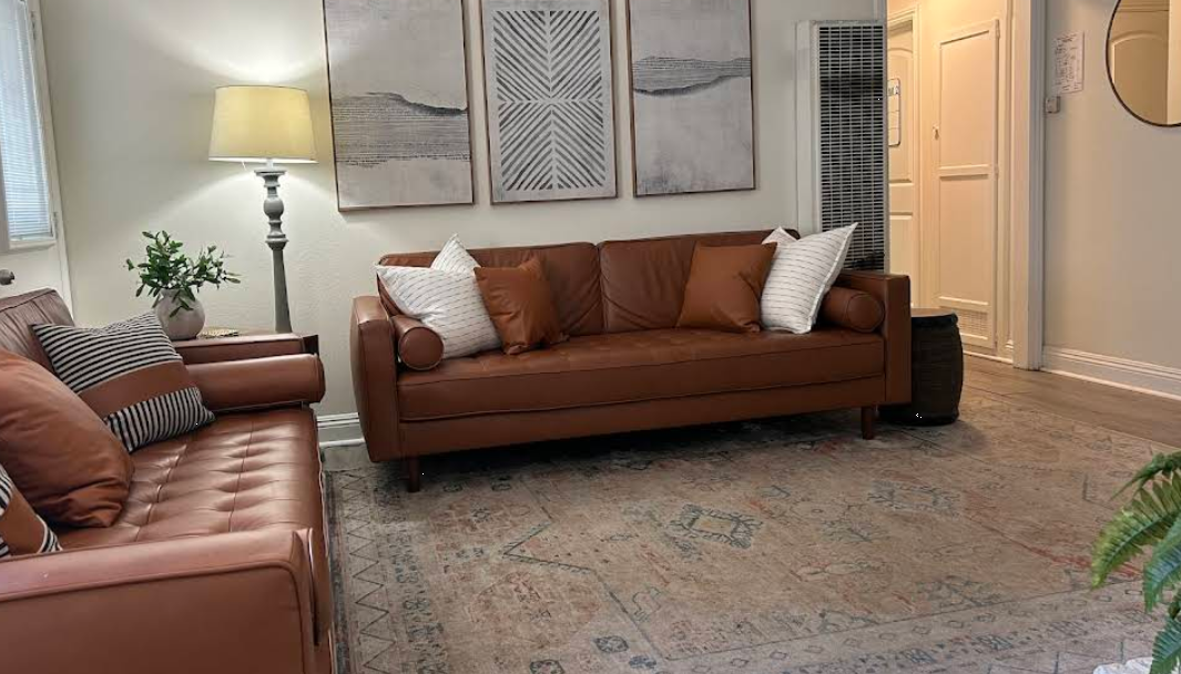 Warm living room with brown sofas and neutral decor
