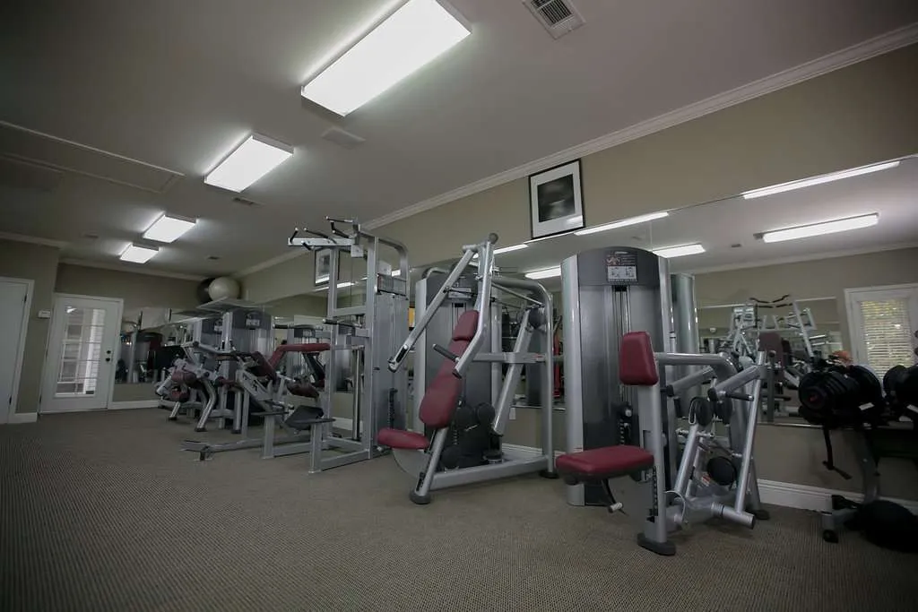 Gym with weight machines and mirrored wall