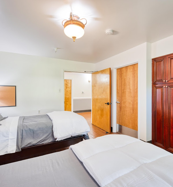 Resident bedroom with comfortable beds and storage cabinets