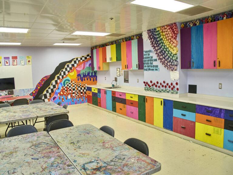 Colorful art therapy room with tables and creative supplies