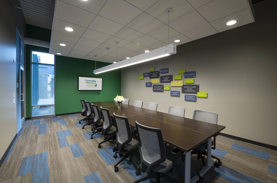 Meeting room with long conference table and office chairs