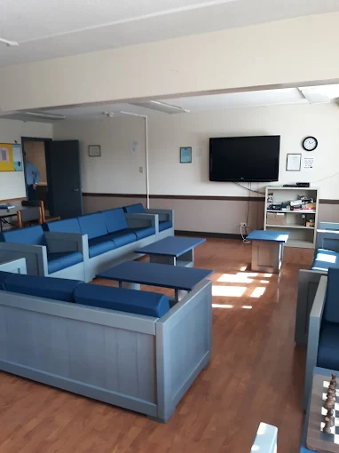 Meeting room with blue seating and whiteboard