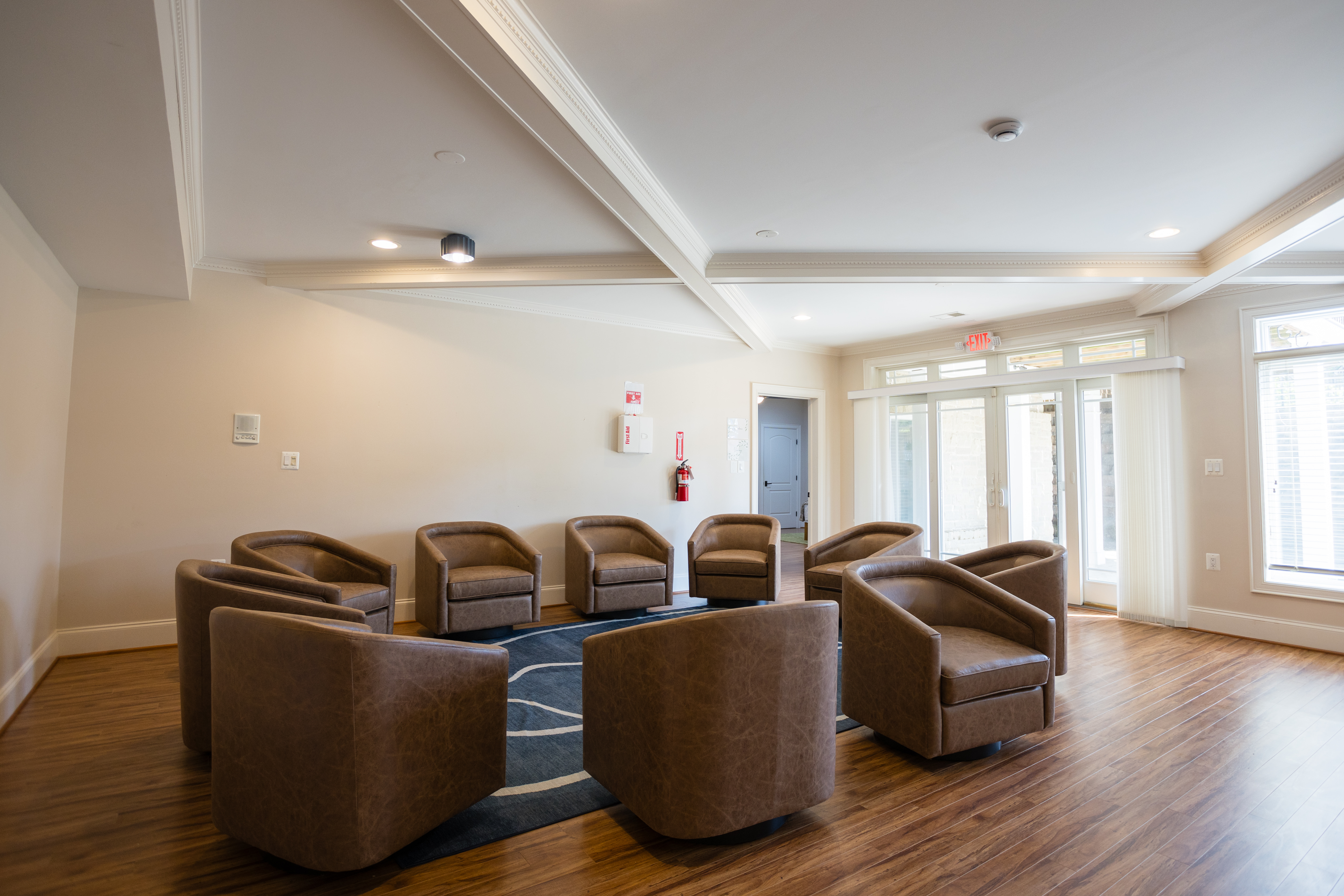 Circle of leather chairs in bright therapy room