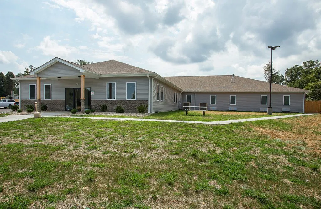 One-story rehab facility building with sidewalk and lawn