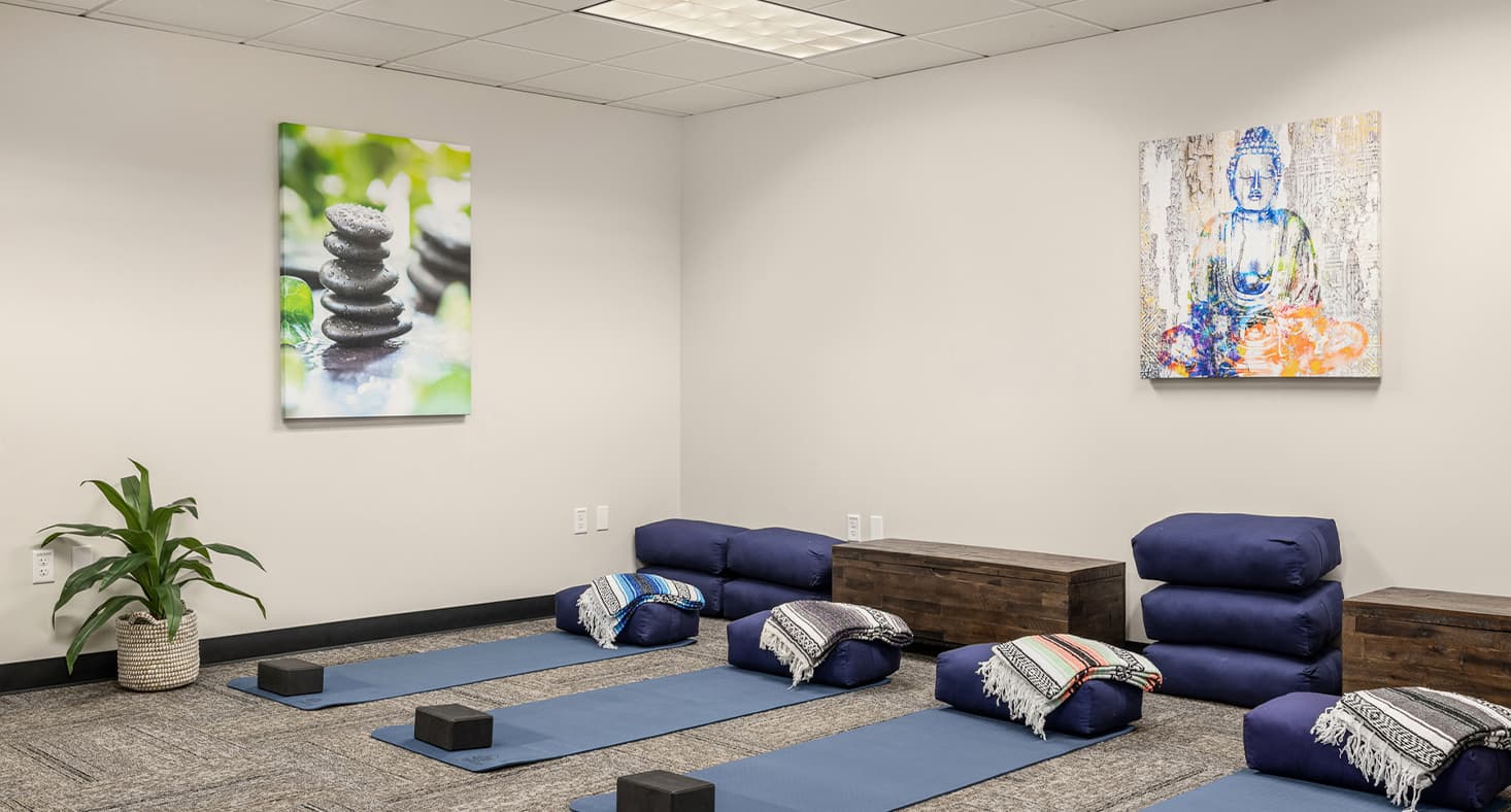 Yoga room with mats and cushions.