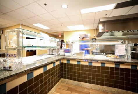 Food service counter with trays and hot meal station