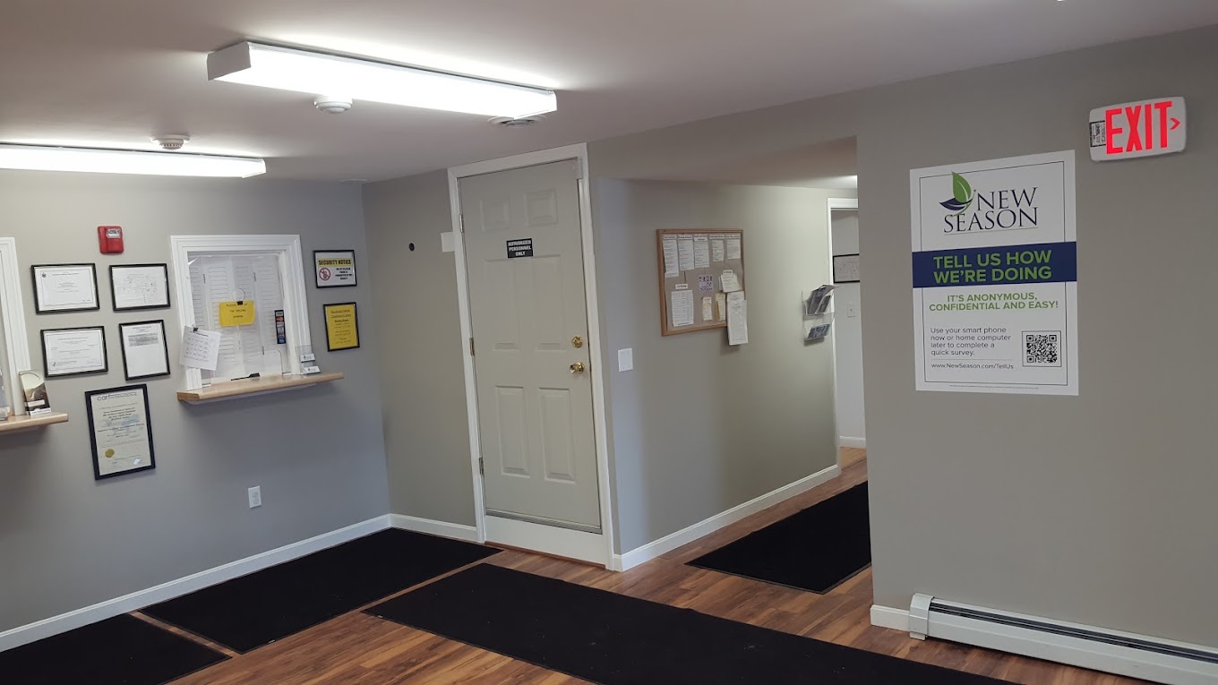 Reception window wiith signage on wall.