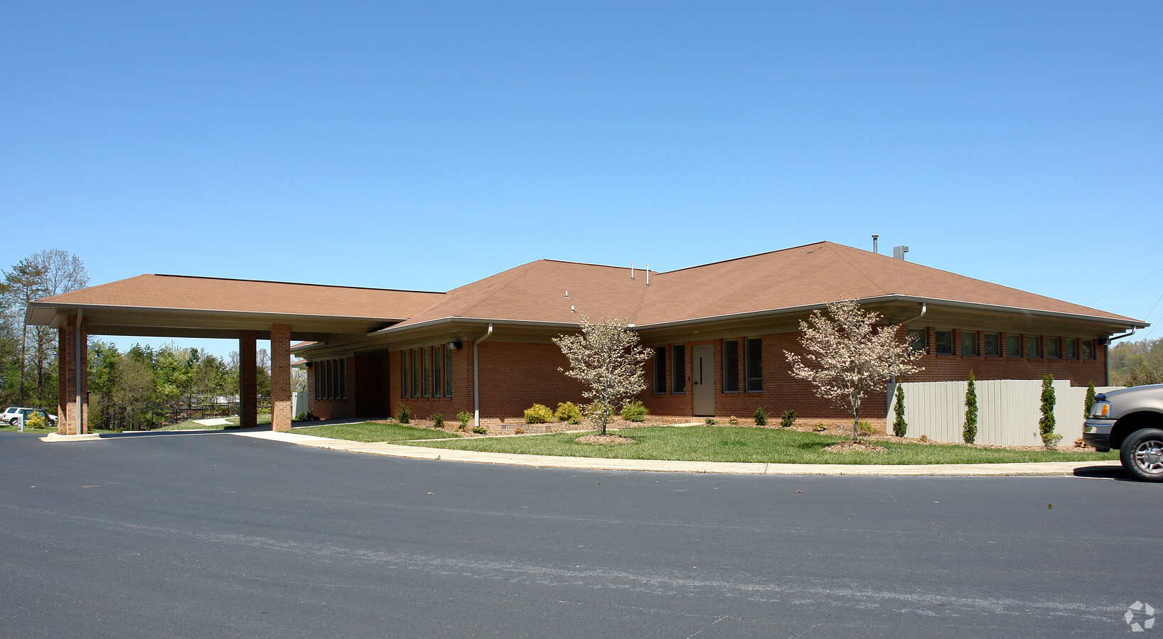 Facility building with entrance and accessible parking.
