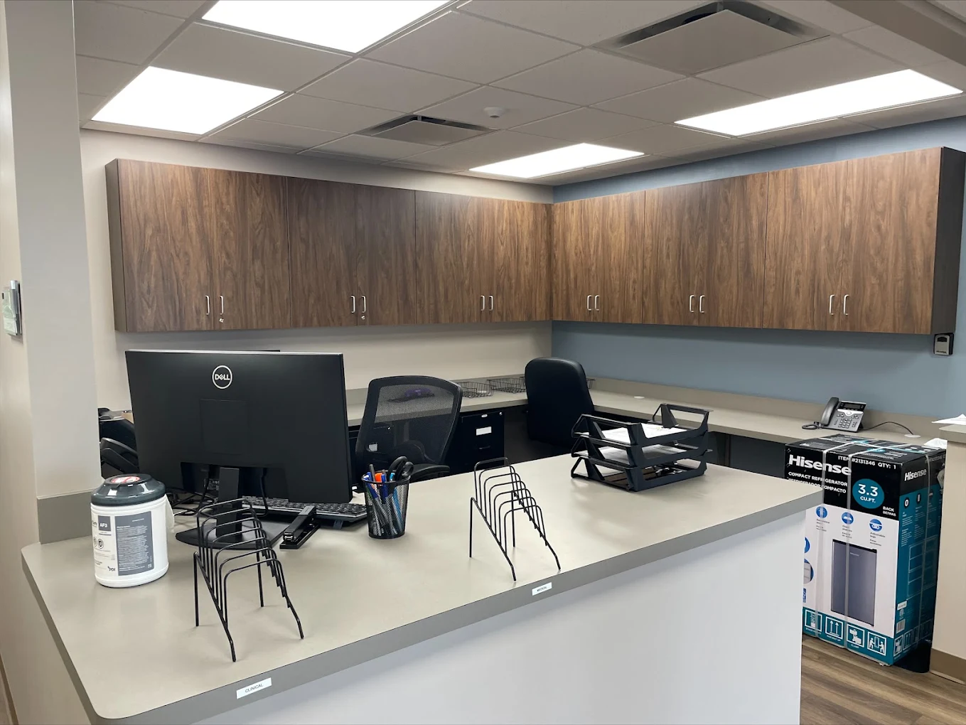 BrightView Fredericksburg staff workstation with computer, counters, and overhead cabinets