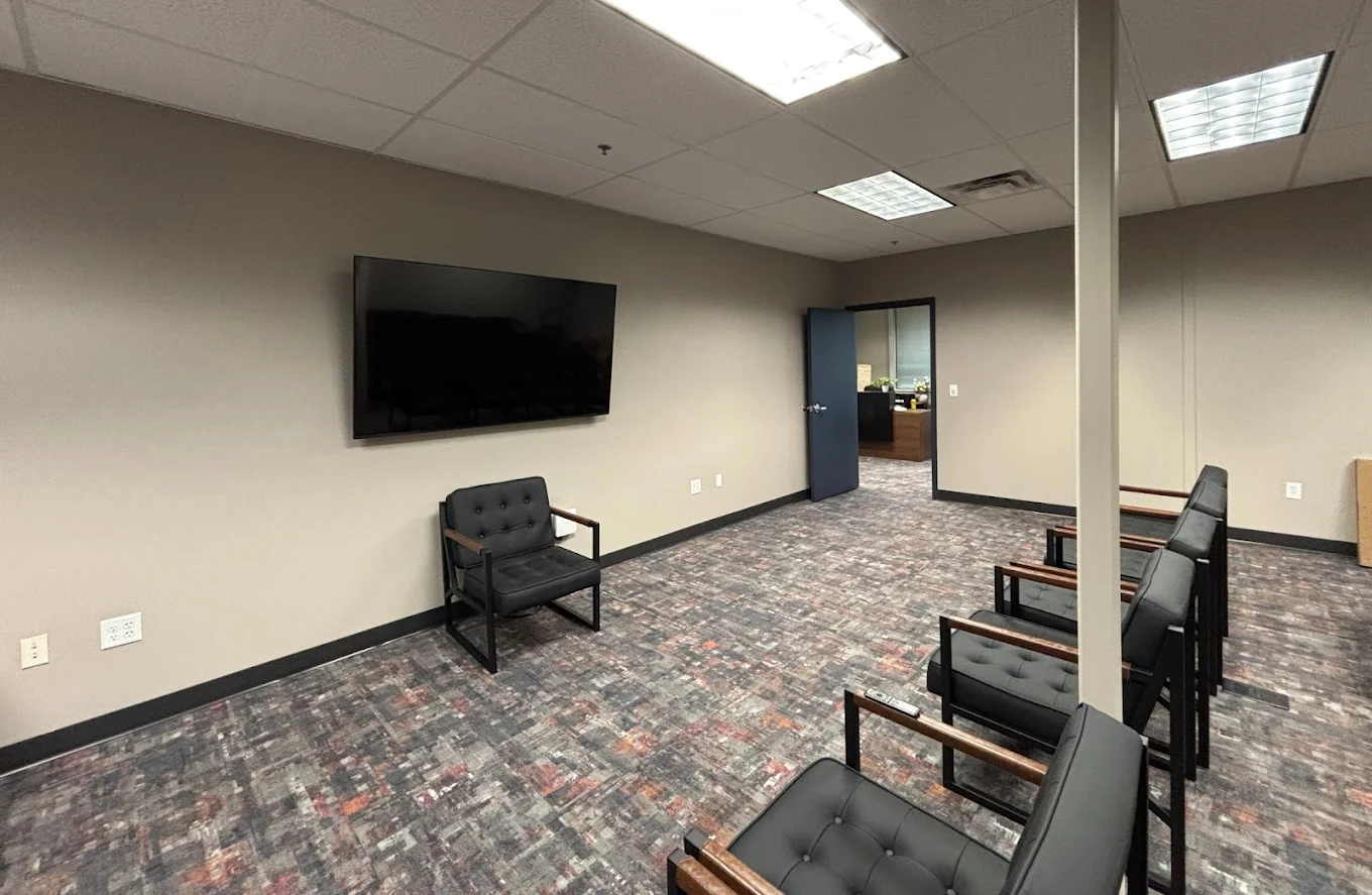 Waiting area with chairs and wall-mounted TV