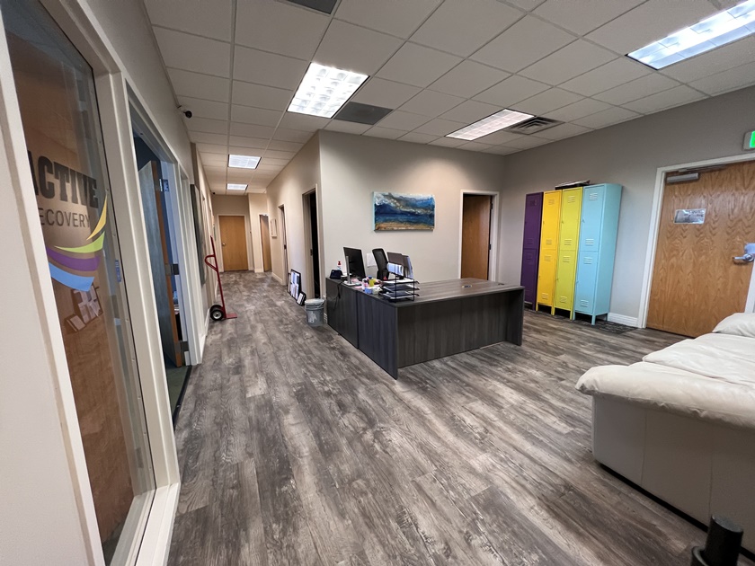 Lobby with front desk, colorful lockers, and modern flooring at Active Recovery Centerville