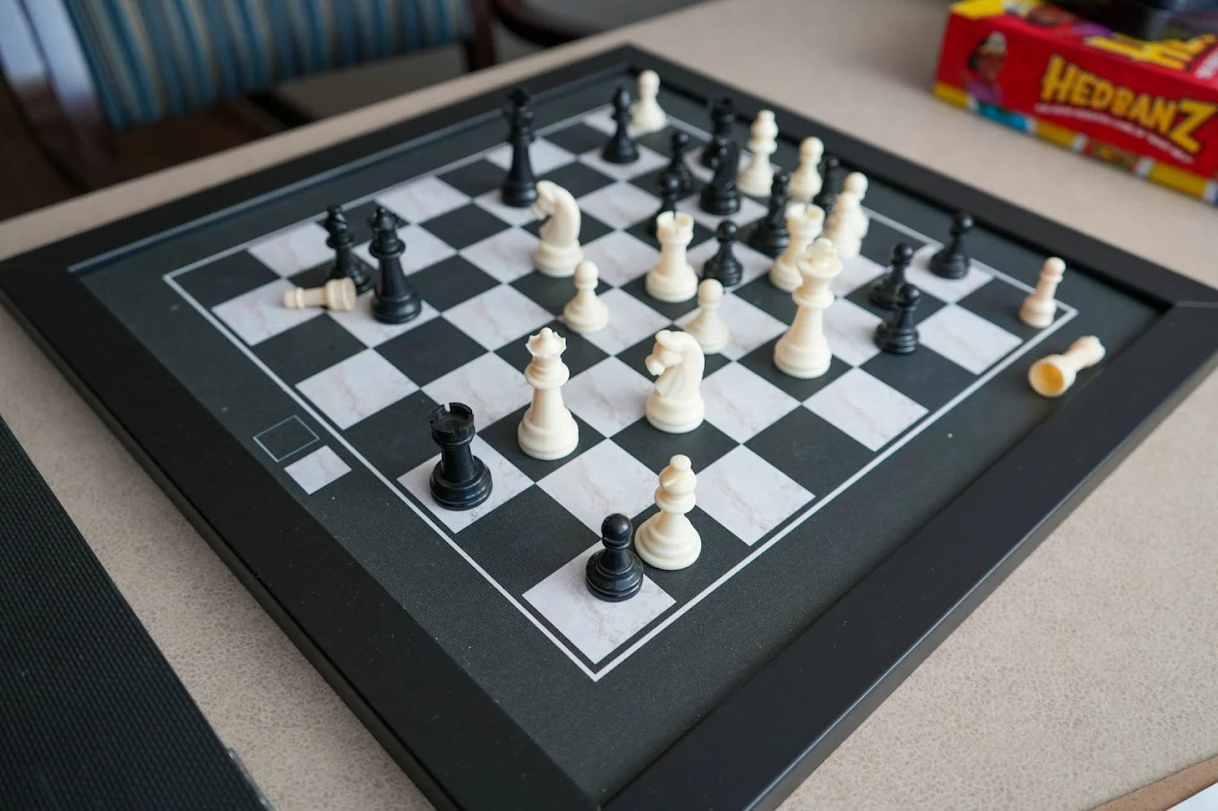 Close-up of chessboard with white and black pieces