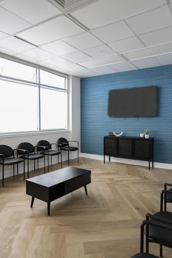 Small meeting space with chairs and wall-mounted TV