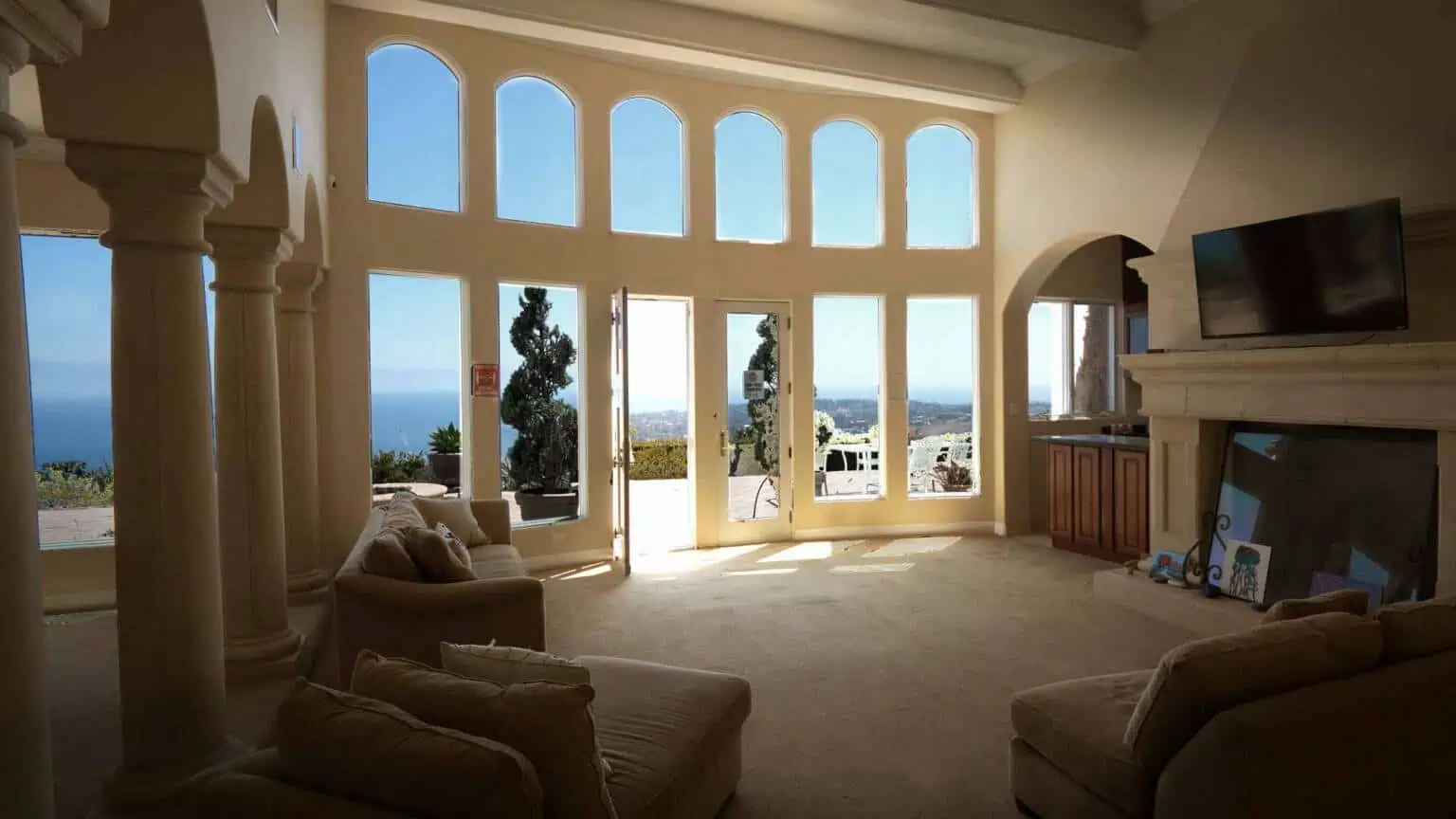 Living room with fireplace and large ocean-facing windows