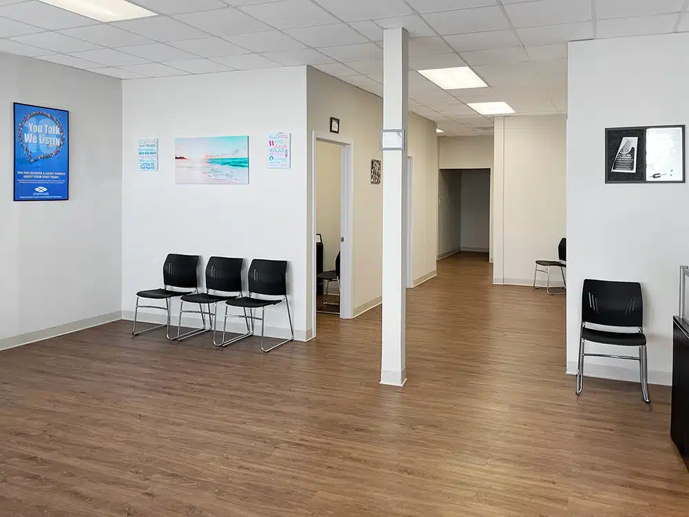 Open lobby with chairs and hallway leading to rooms