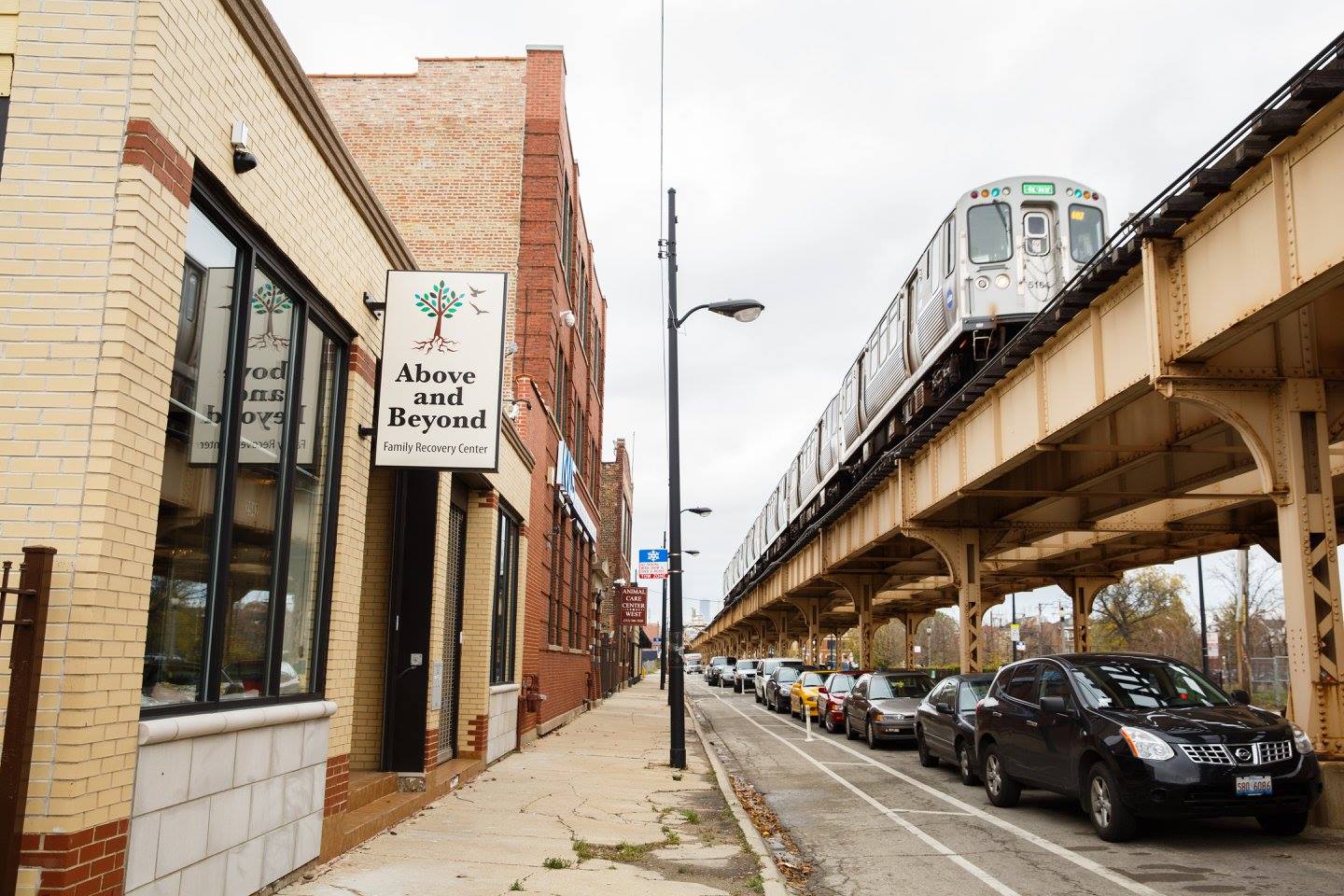 Facility exterior beside elevated train and street traffic