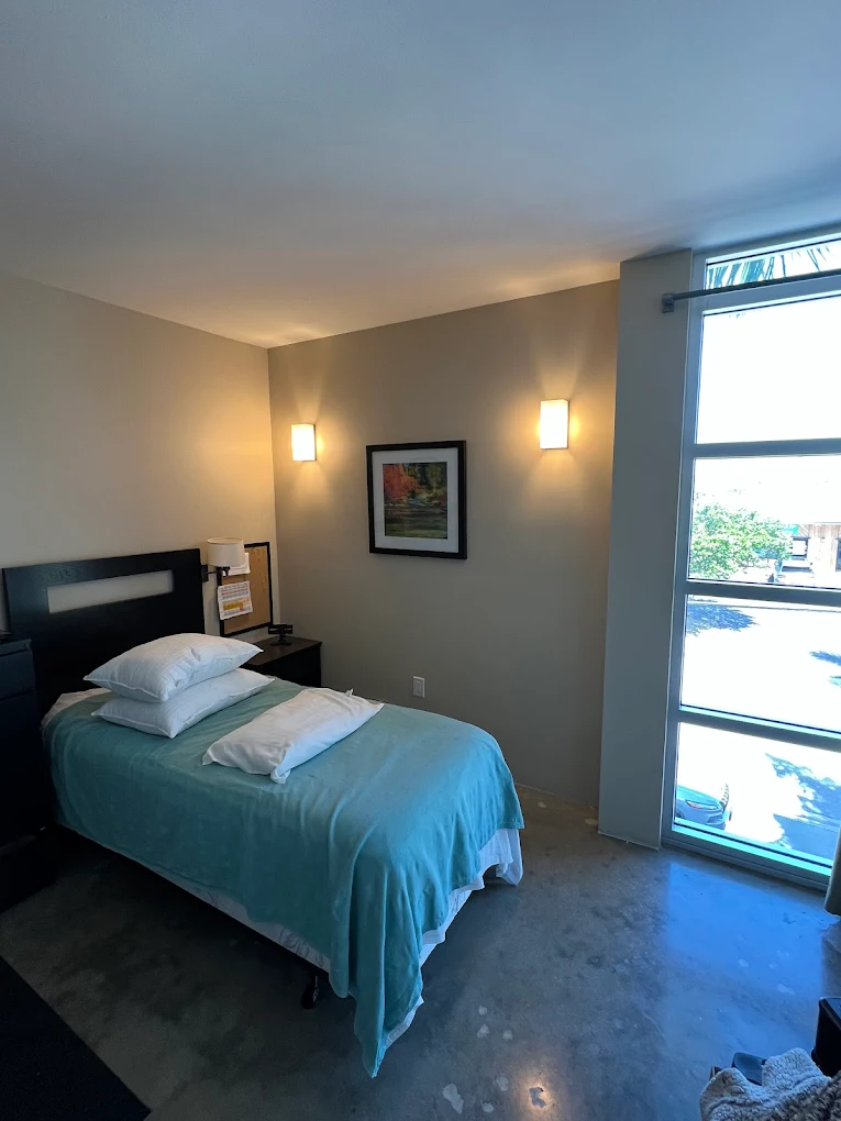 Private bedroom with bed and window in Naples rehab condo