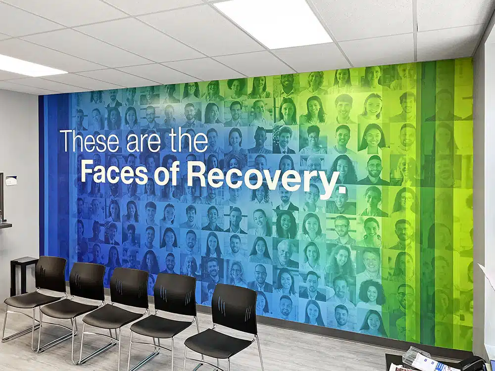 Waiting area with Faces of Recovery mural and chairs