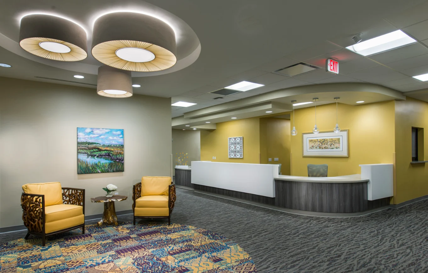 Reception desk with yellow seating and colorful decor