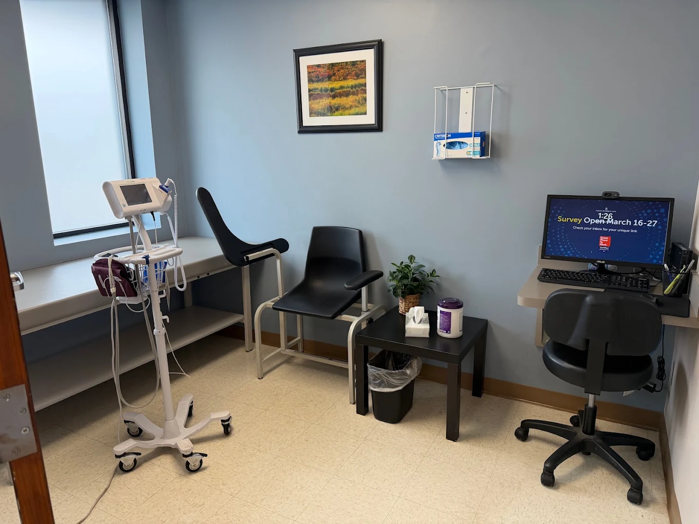 Exam room with medical equipment and seating