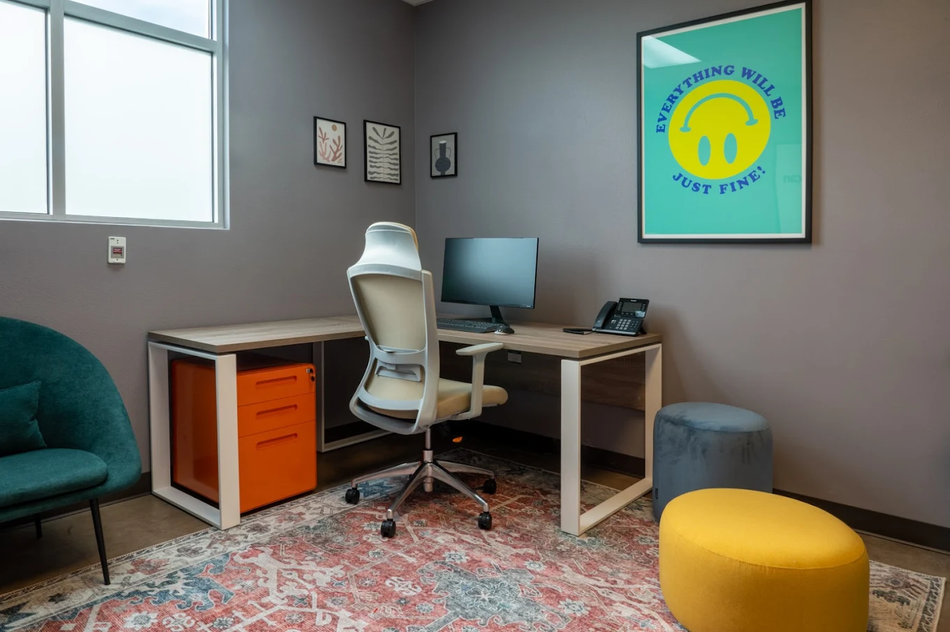 Private therapy office with desk and seating