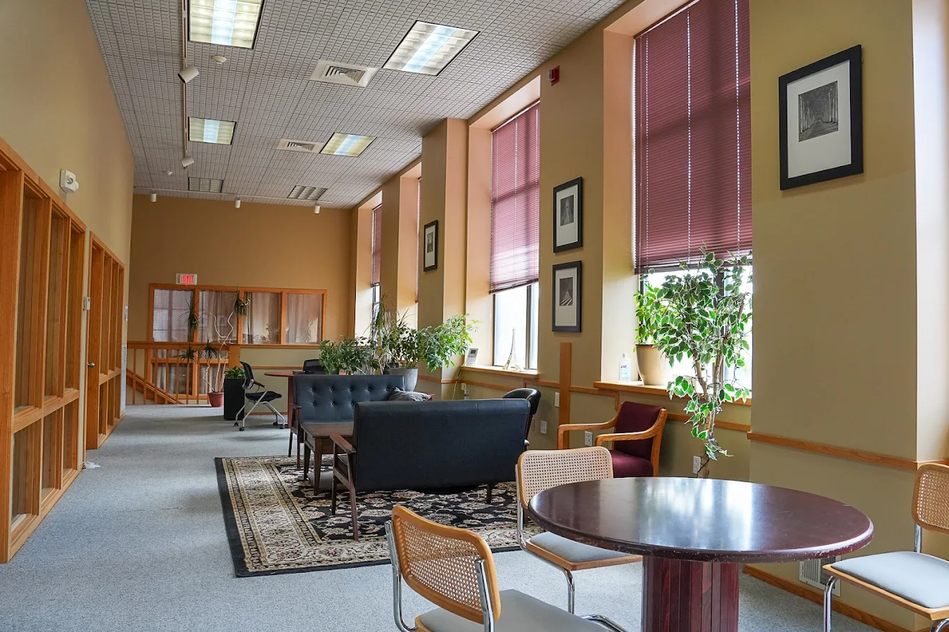 Lounge with couches, chairs, and natural light
