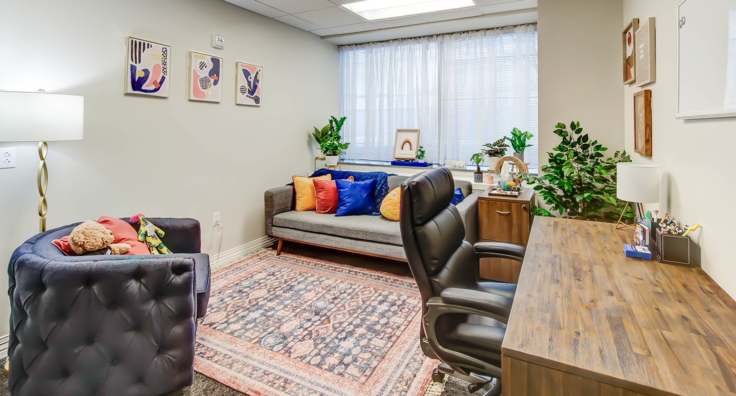 Therapist office with cozy sofa and desk