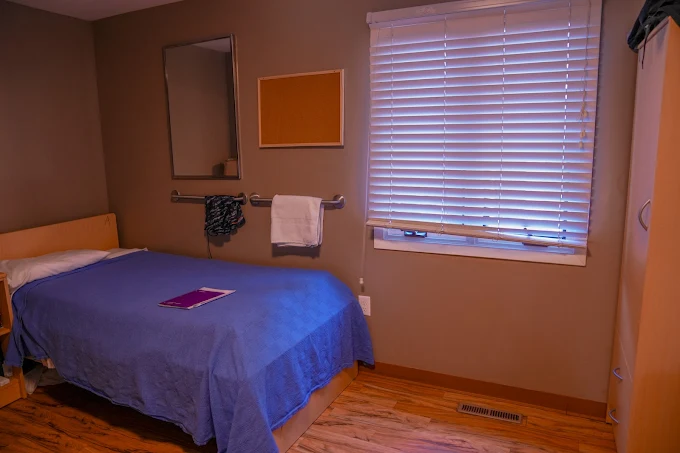 Single bedroom with bed, desk, and window