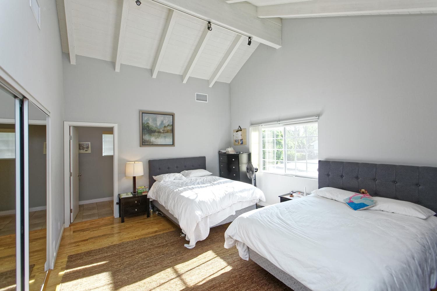 Spacious bedroom with two beds and vaulted ceiling