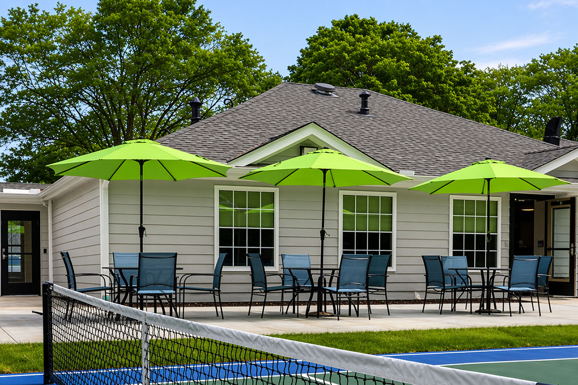 Patio seating area beside outdoor recreation courts