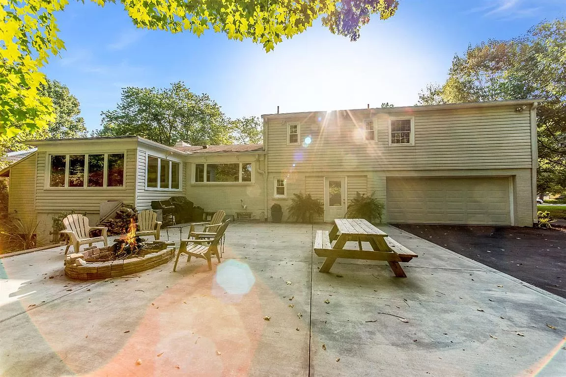 Outdoor backyard wth seating and fire-pit.