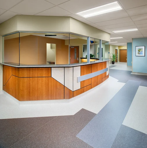 Modern reception desk with glass divider and hallway