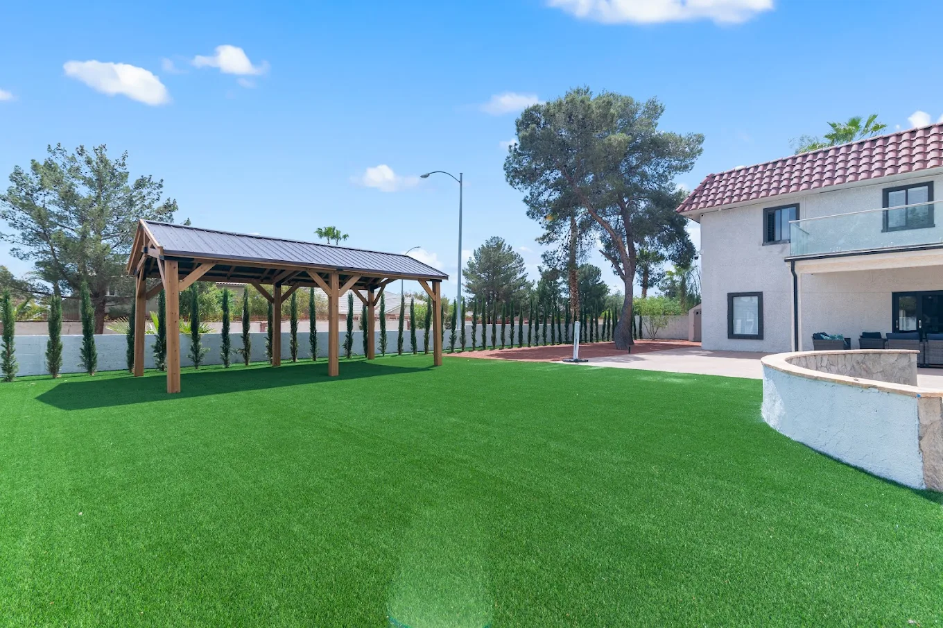 Spacious courtyard with artificial turf and gazebo