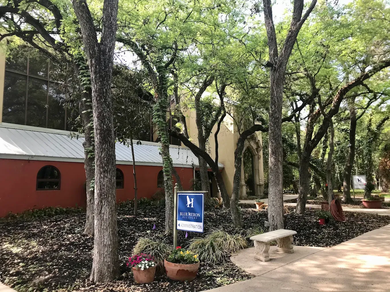 Front entrance surrounded by mature oak trees and gardens