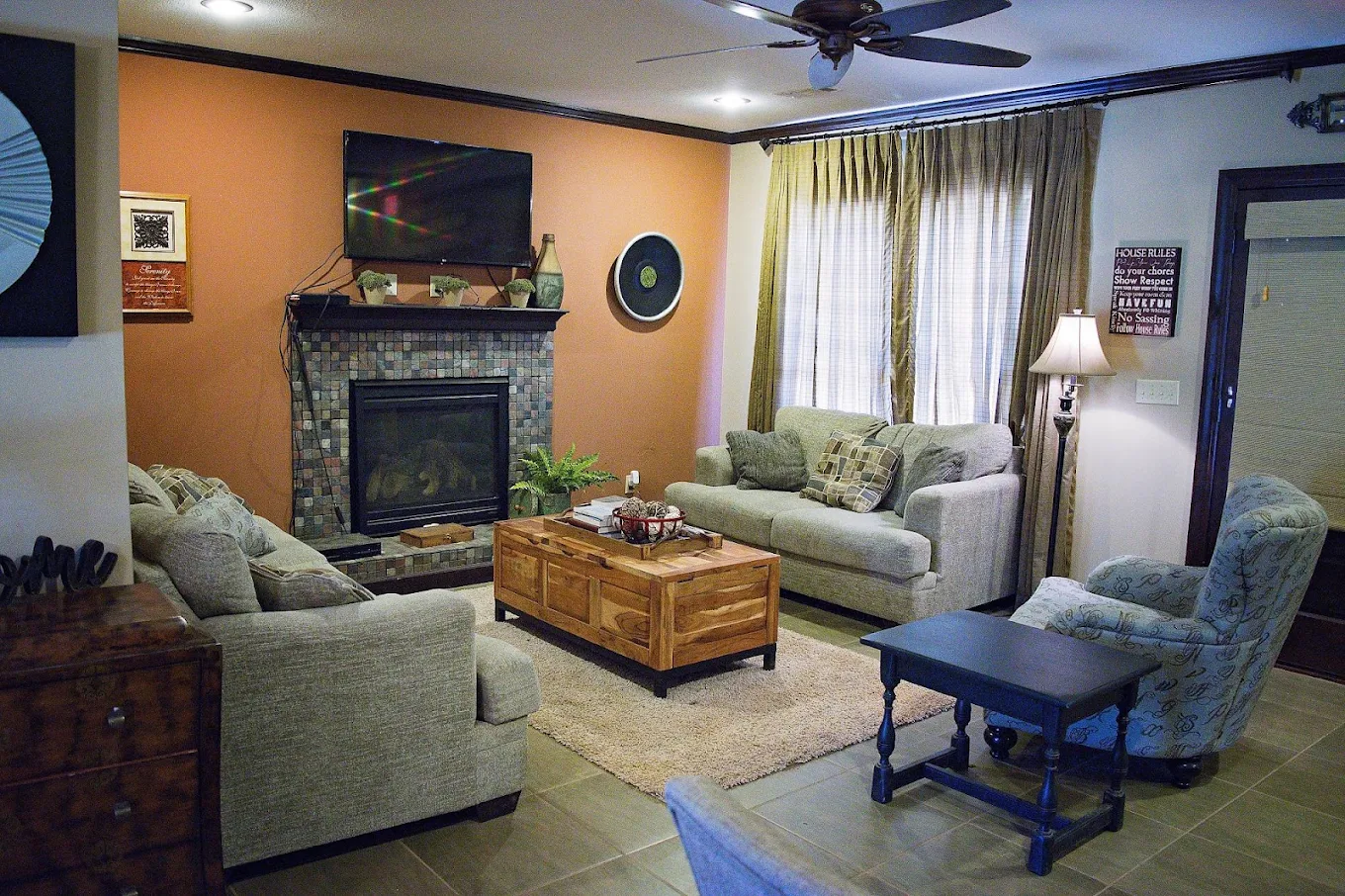 Living room with fireplace, sofas, and armchairs