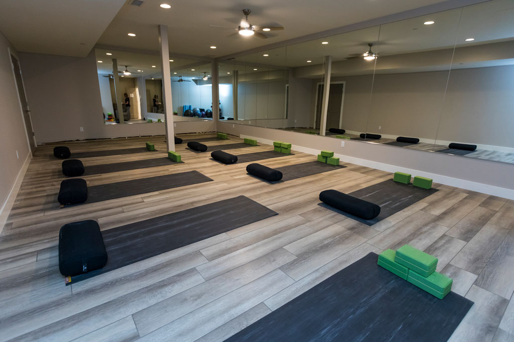 Yoga studio with mats, mirrors, and wellness props