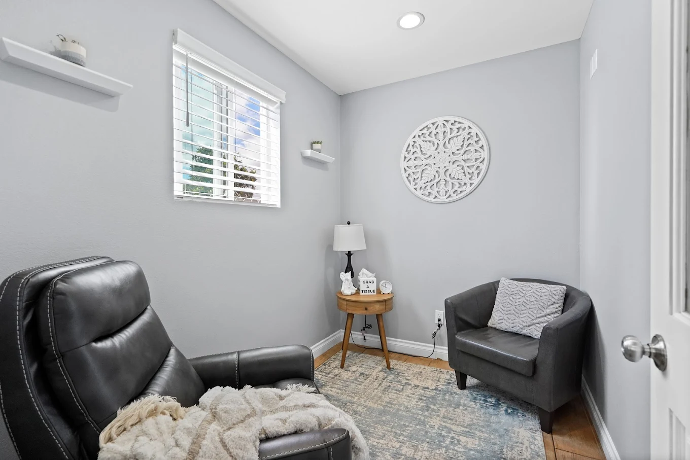 Small therapy room with two armchairs and window