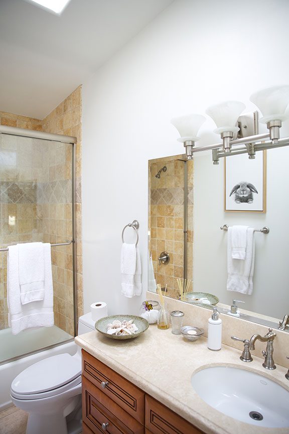 Clean bathroom with glass shower and vanity counter