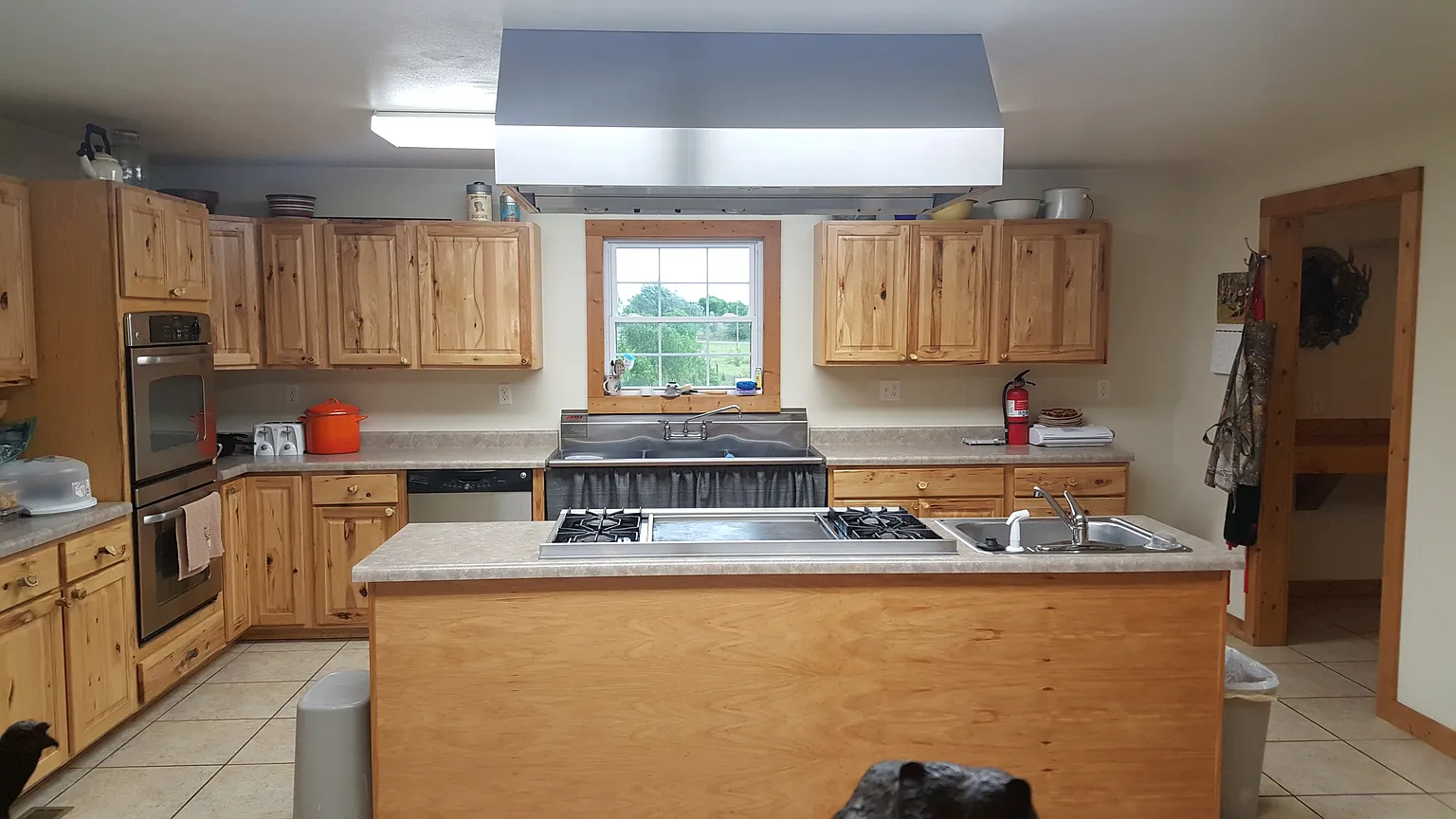 Modern and functional kitchen at Kisa Life Recovery Sedan, equipped with wooden cabinetry and ample counter space.