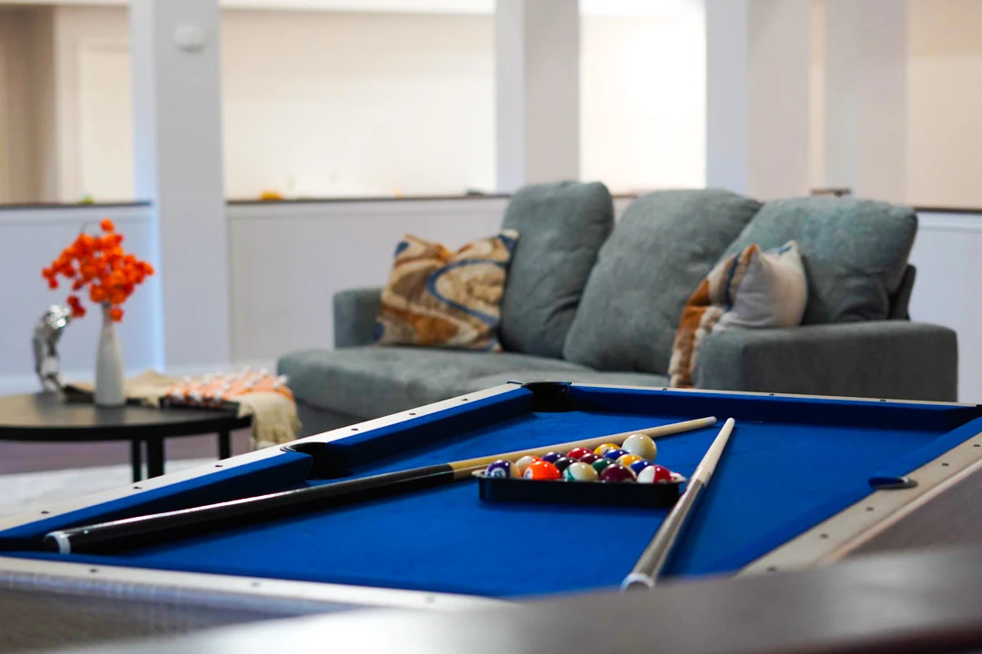 Pool table and seating in recreation room