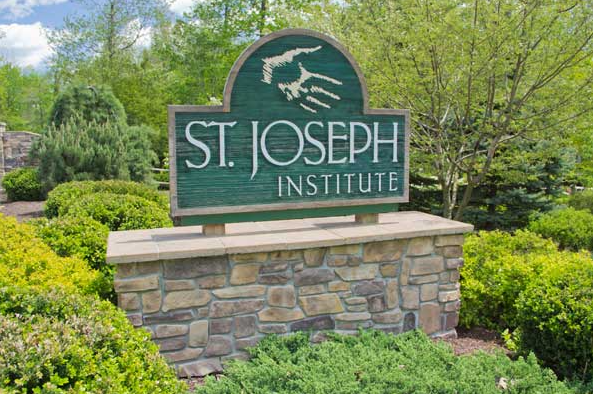 Saint Joseph Institute sign at the entrance surrounded by landscaping